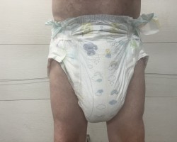 Baby in soaked pampers diaper