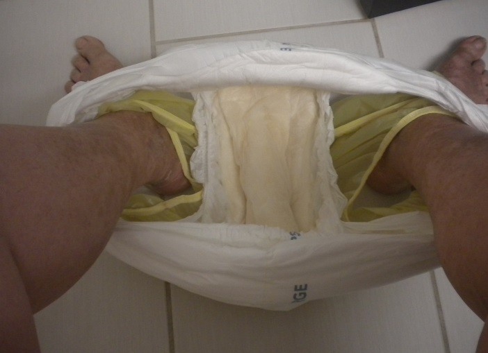<p>Sitting on the toilet with my already wet diaper and plastic pants pulled down to poo.</p>