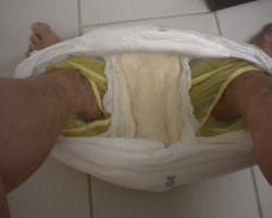 Sitting on the toilet with my already wet diaper and plastic pants pulled down to poo.