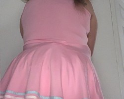 My pink polka dotted ruffled butt plastic panties are peeking out from under my dress.