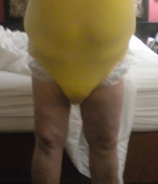 <p>Yellow snap crotch onesie over my diaper and clear rustle plastic pants.</p>