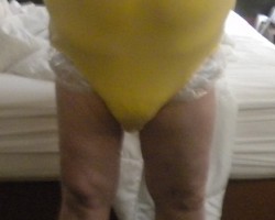 Yellow snap crotch onesie over my diaper and clear rustle plastic pants.